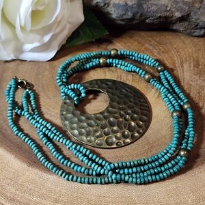 Vintage Necklace With Wooden Turquoise Beads And A Hammered Bronze Pendant